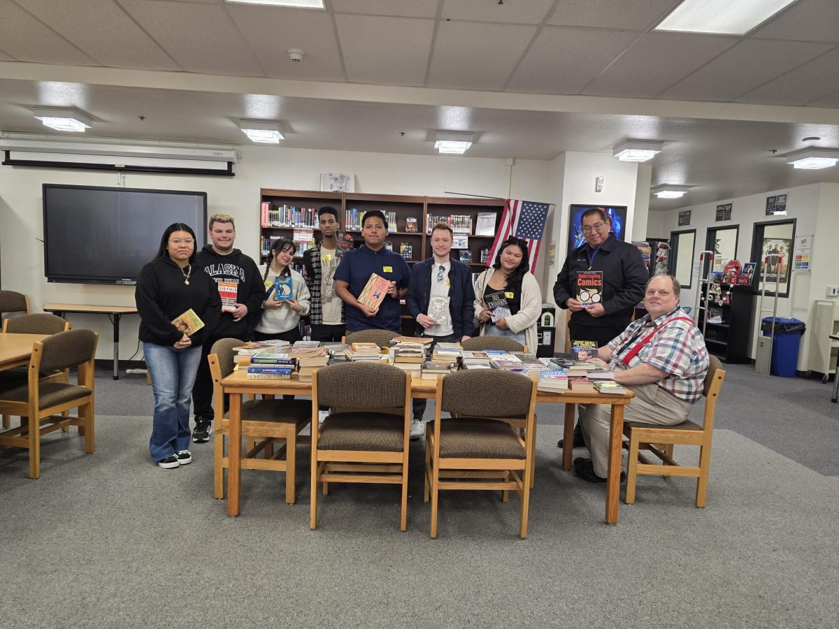 NAHS Students and staff Nicolas Glickman, Kendra Yacuta-Rodriguez, Principal Lee, and Librarian Kent receving the books from CSUN's English Honor Society 