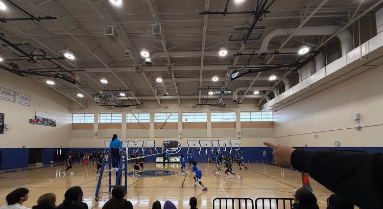 Boy Volleyball playing a home Game