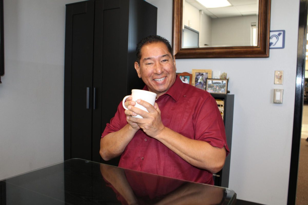 Mr.Lee holding a coffee mug.